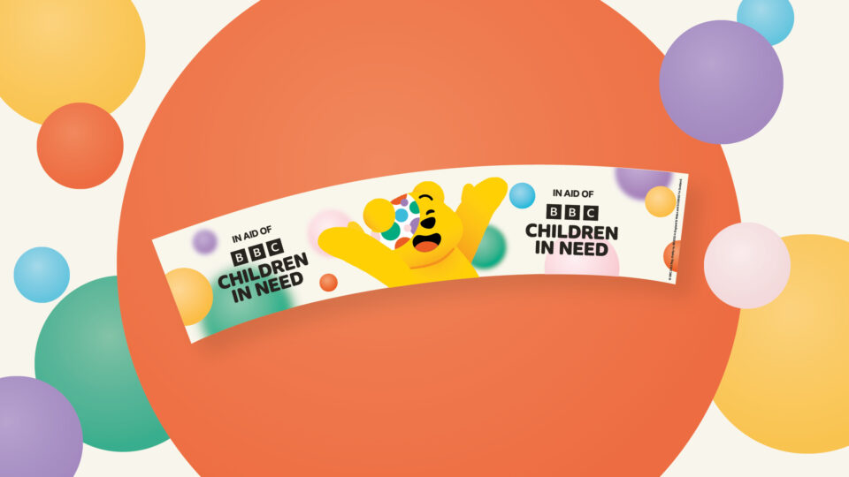 A curved label to be cut out a stuck to a collection bucket, featuring Pudsey