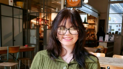 Lily smiling in a cafe