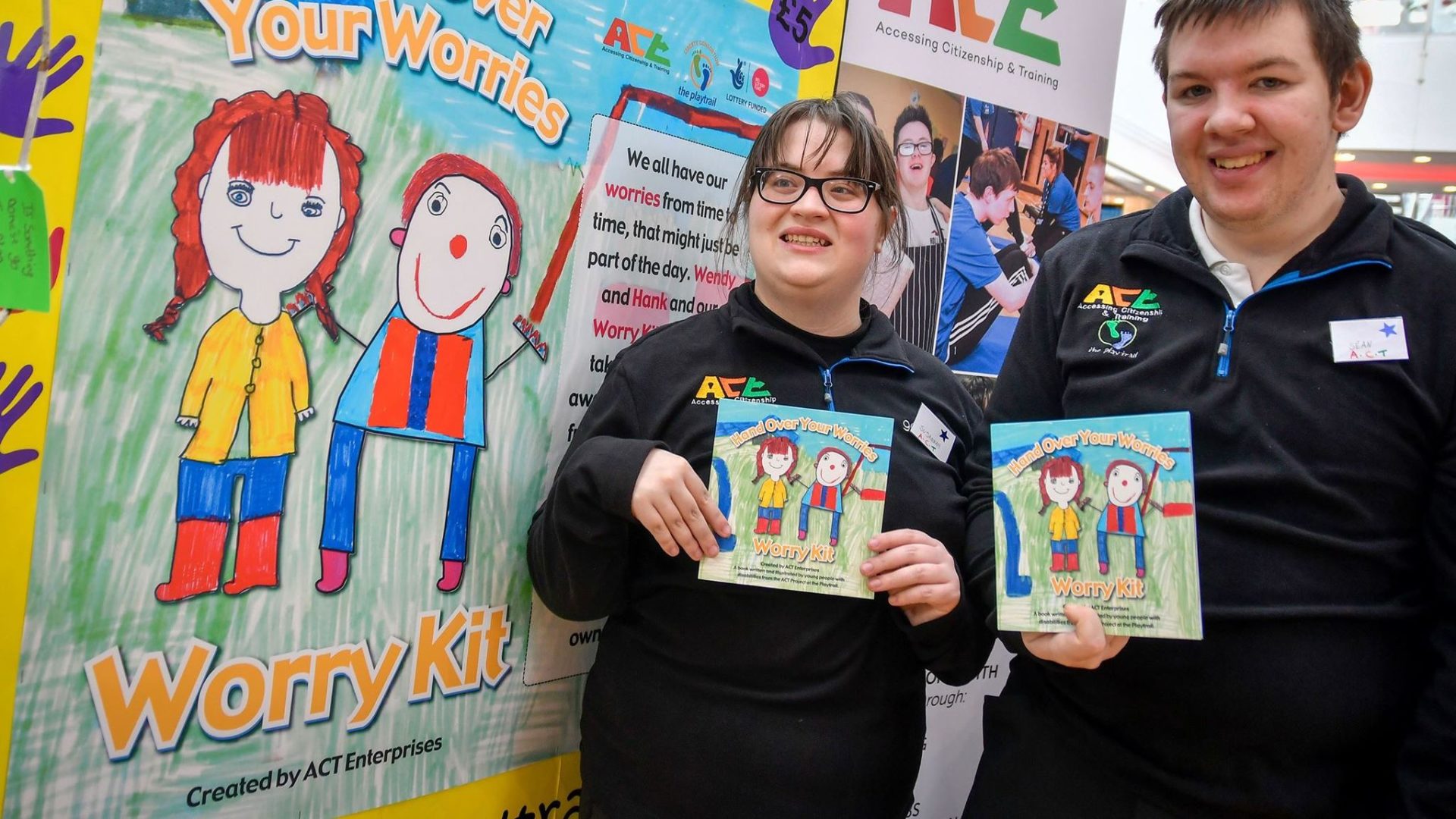 Young people proudly holding a Worry Kit they helped to develop