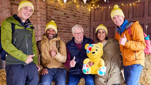 The cast of Countryfile in yellow bobble hats and holding a Pudsey