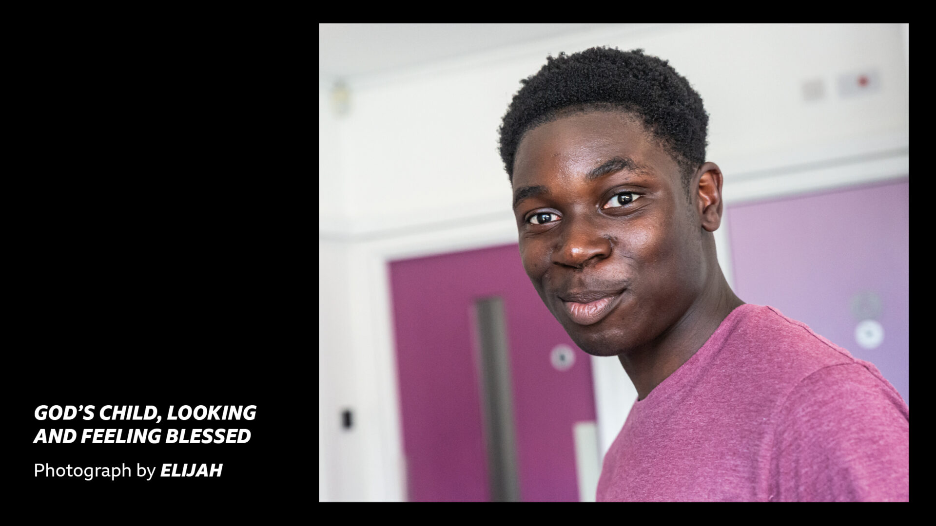 'God's child, looking and feeling blessed - Photograph by Elijah' - a teenage boy in a pink top looking directly at the camera