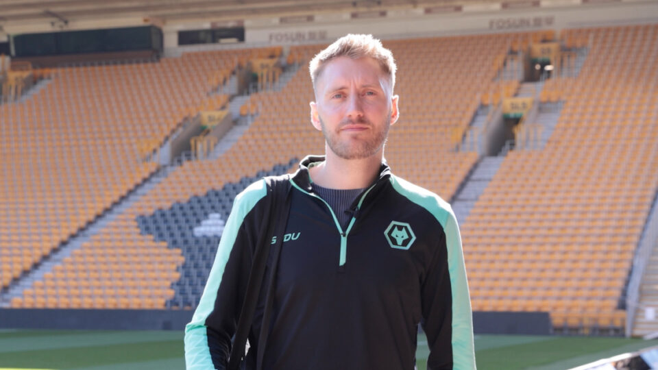 A man wearing a tracksuit in a sports stadium